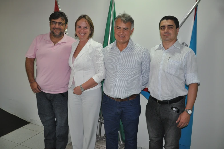 three men standing beside a woman in white