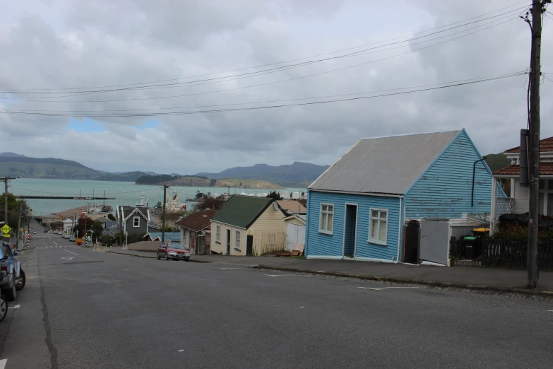 a city street with a small blue building