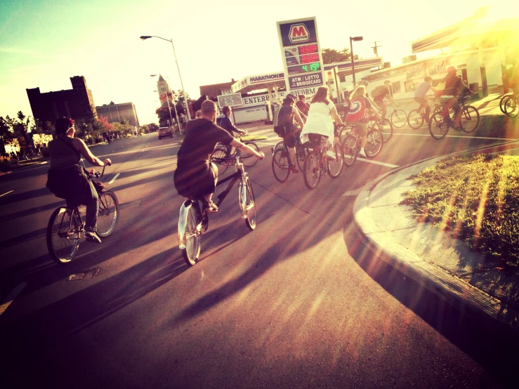 group of bicyclists riding down an urban street