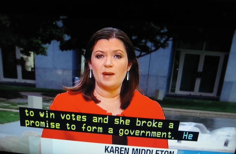 a woman who is on a news tv talking to someone
