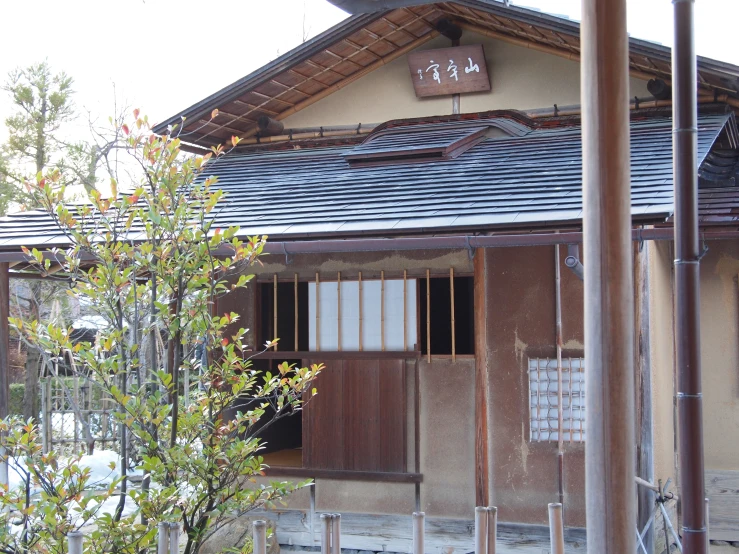 an old style building with shingled windows and a wood gate