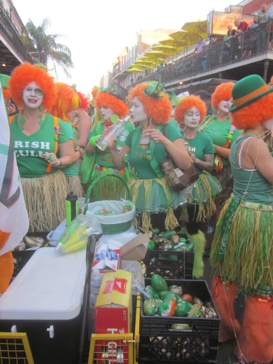 some women in green and orange costumes posing