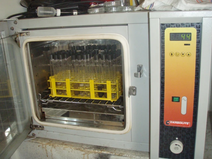 a machine with plastic bottles on it is near some sort of a counter