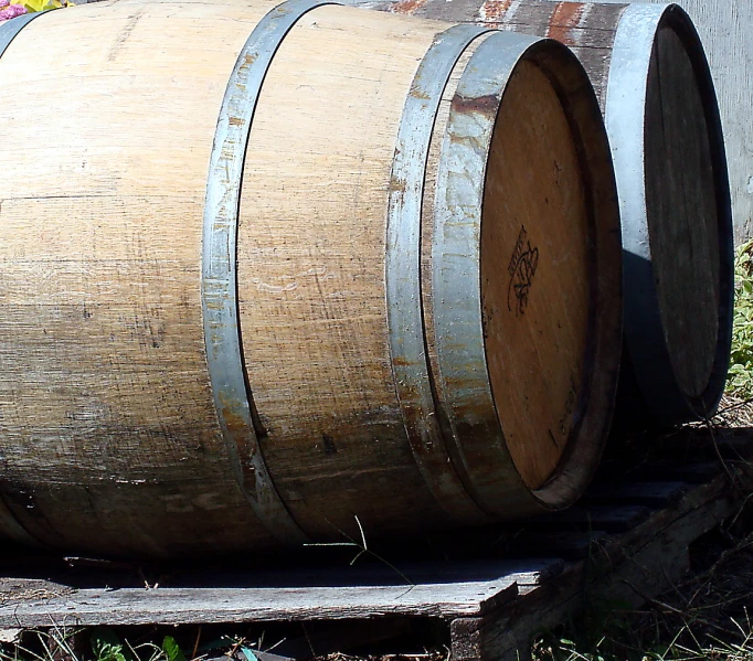 a couple of wooden barrels sitting in a yard