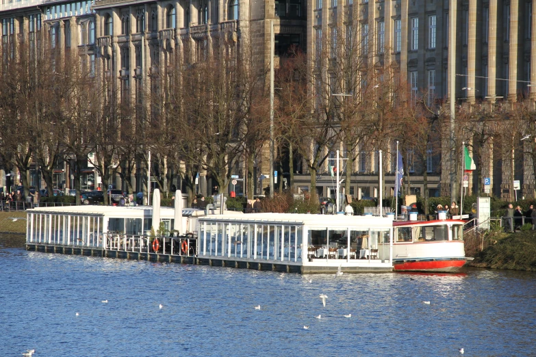 a white house boat sitting on top of a river