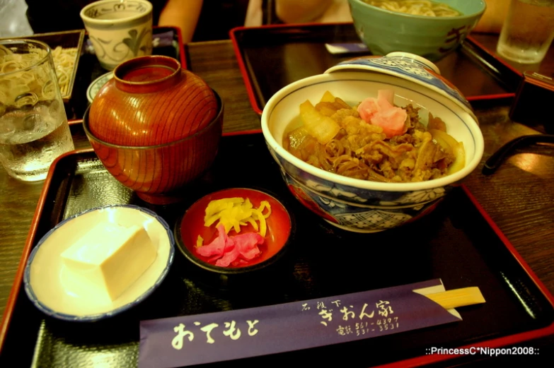 an oriental dish with many different ingredients and small serving bowls