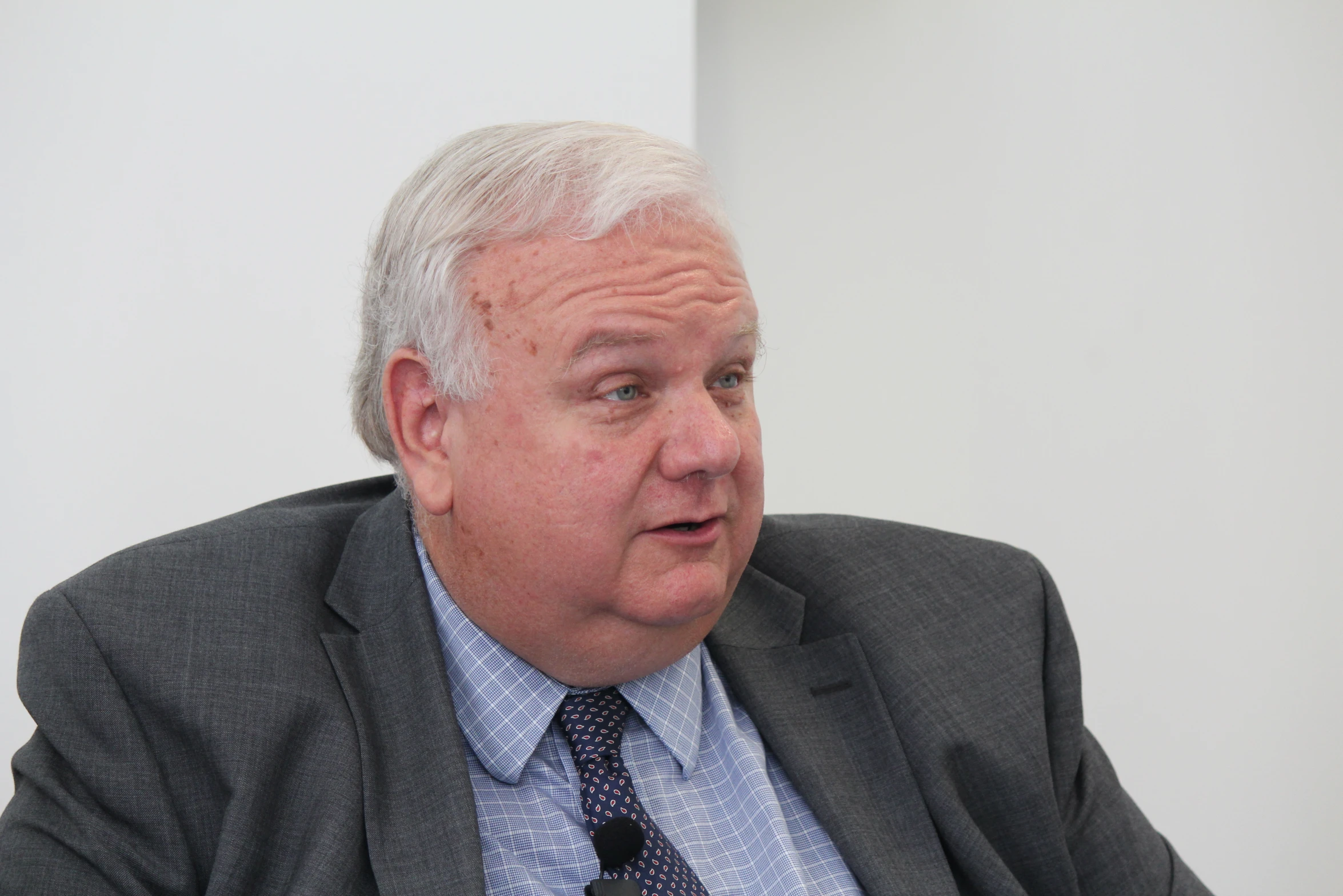 an older man wearing a suit and tie