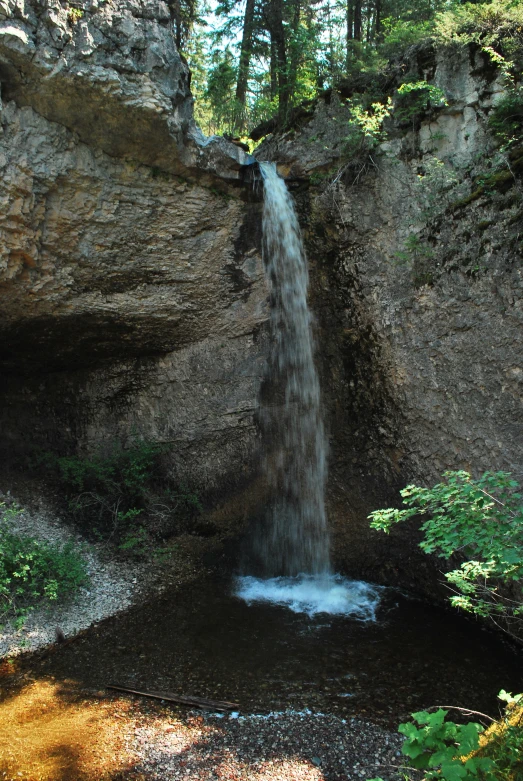 a large waterfall is going down a canyon