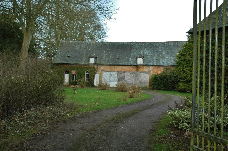 an old house sits out in the country side