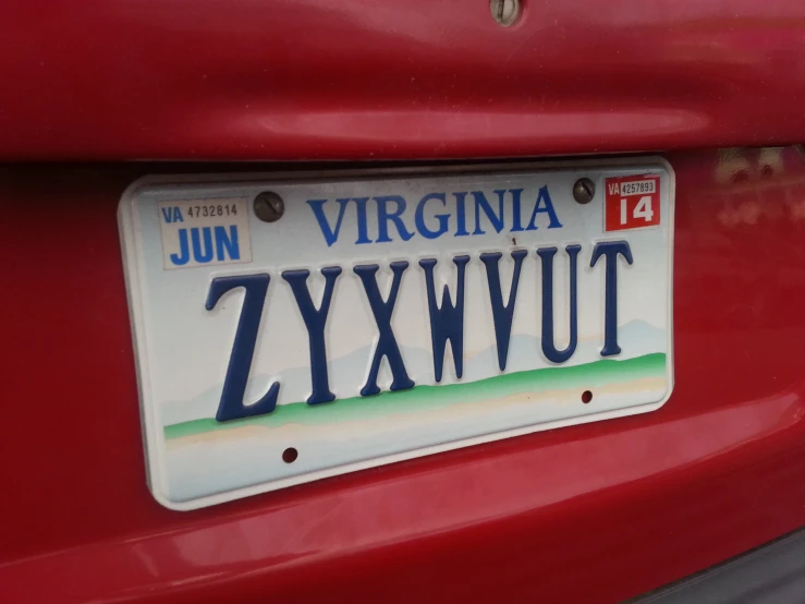 a license plate attached to the side of a red car