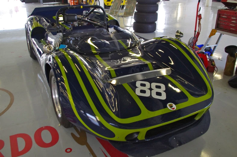 a sport car on a work surface in a repair shop