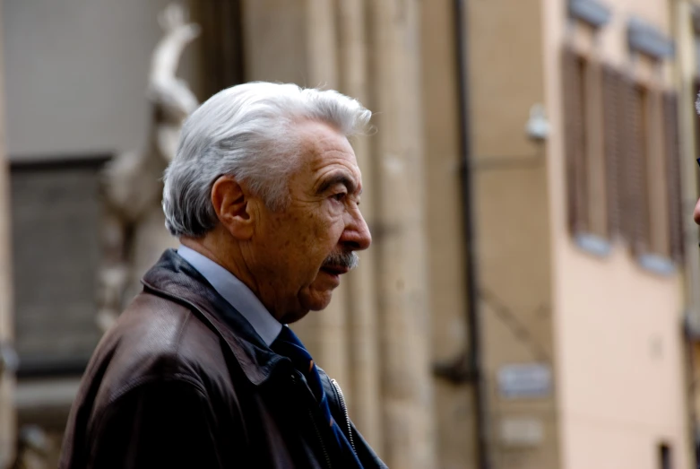 a man standing next to another man next to a building