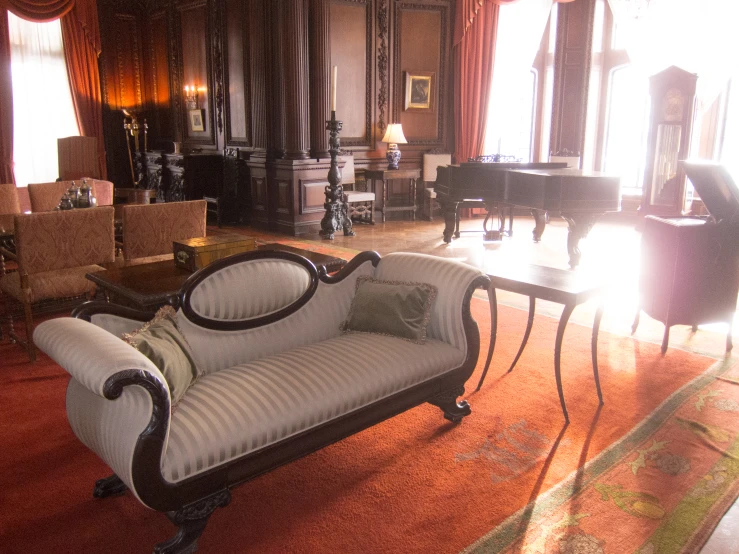 a living room with lots of furniture and a piano