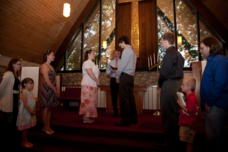 the wedding party looks on as their son walks up the aisle