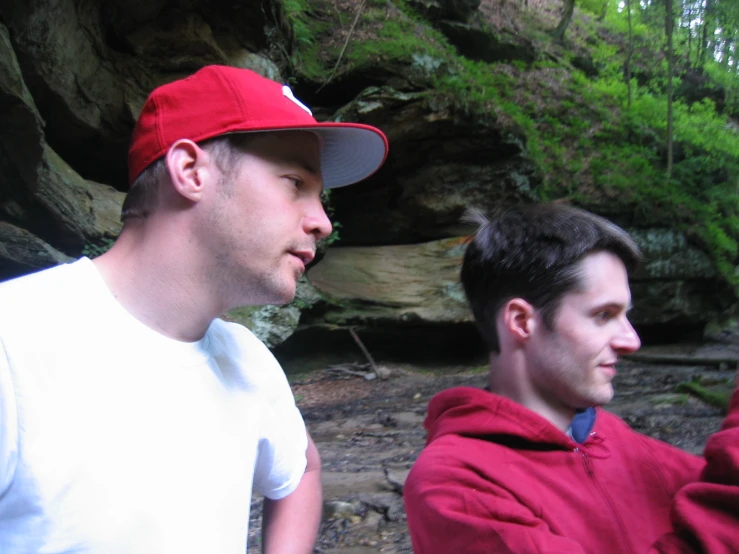 two men in red and white shirts standing next to each other