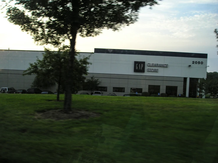 a large building with a green lawn in front of it