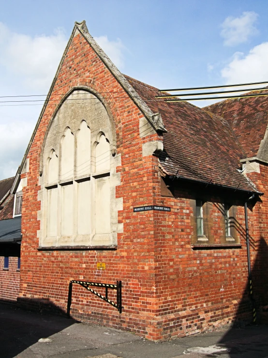 this old brick building has an arched window