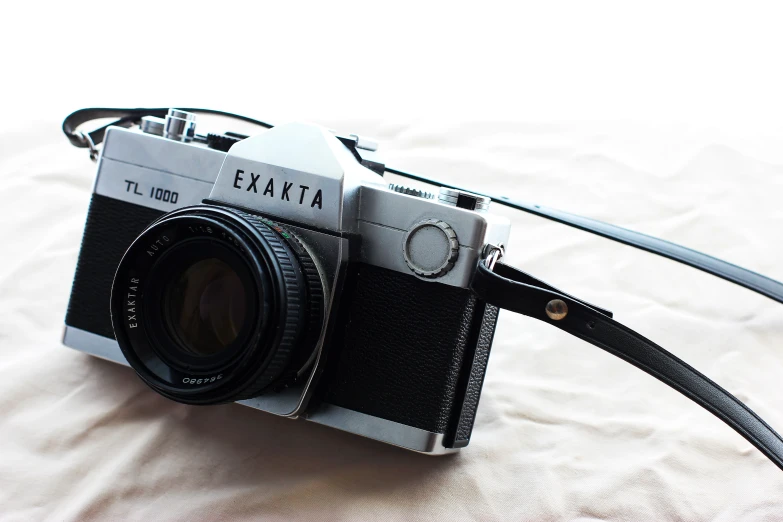 a black and white camera is shown with the strap