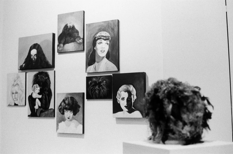 several pictures of women hanging on a wall