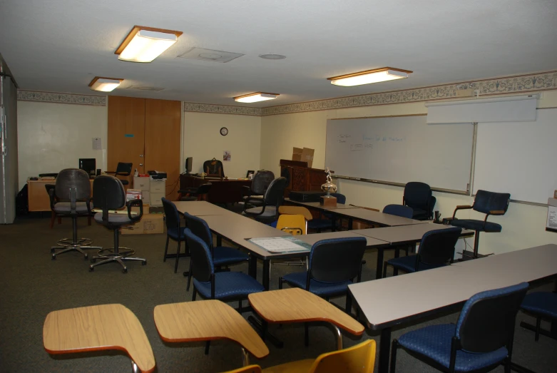 a very large class room with many blue chairs
