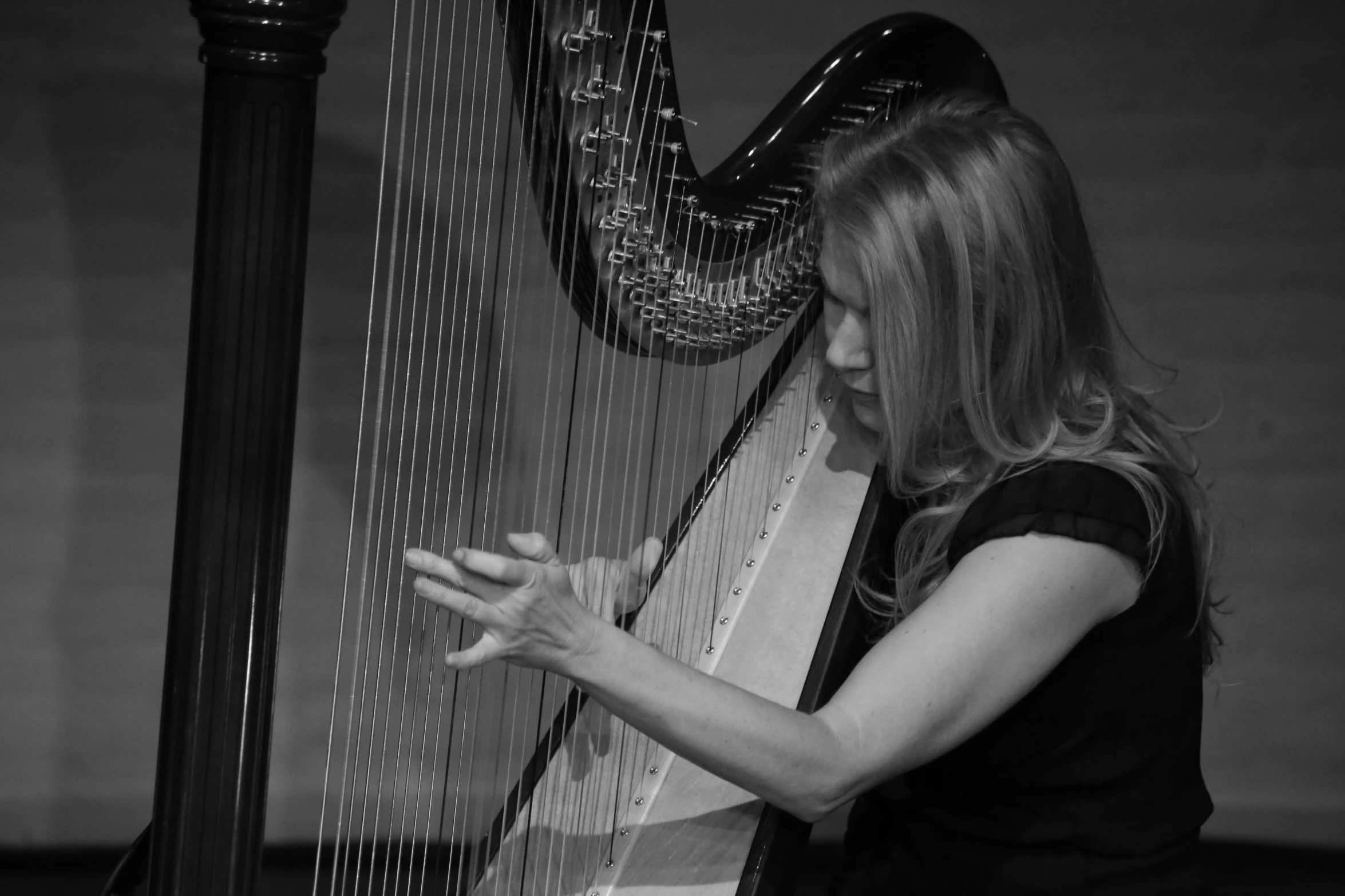 a woman plays on a large instrument with her hands