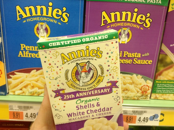 a hand holding up an package of annie's frozen food