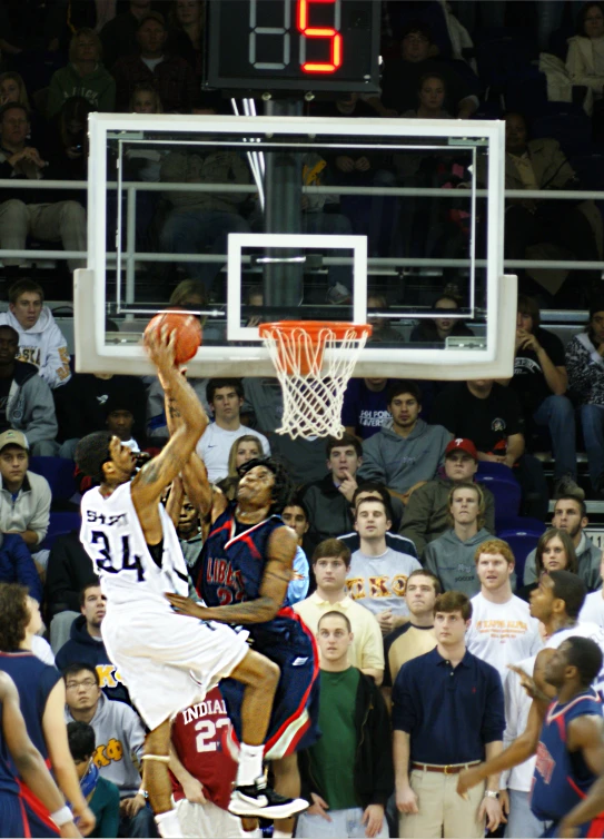 a basketball player is going up for the dunk