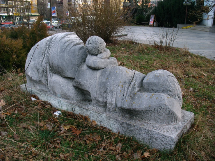 a bench with a sculpture in it on the grass