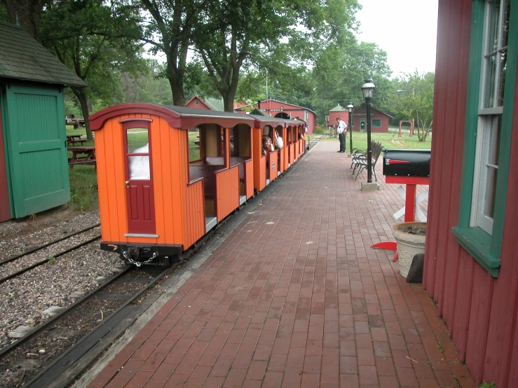 a train is sitting at a small station