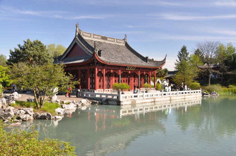 a building with a moat at the center next to water