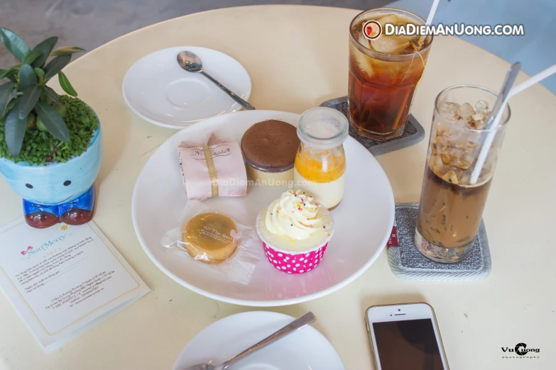 some desserts and ice cream on plates at a cafe