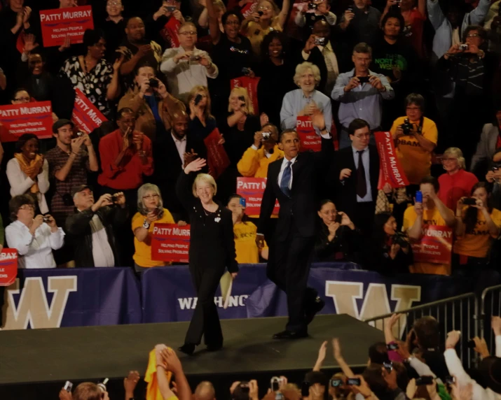 a couple of men are walking up and down a stage