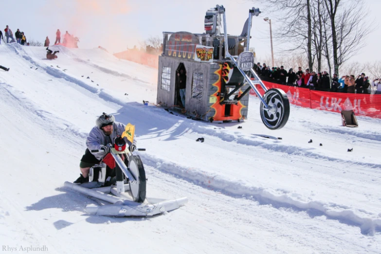 the man is sled skiing down the snowy hill