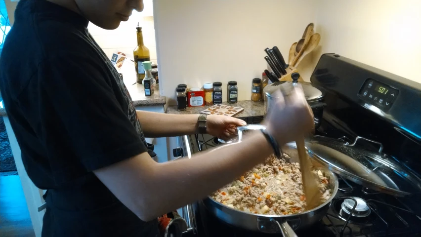 a man is making some food inside of his stove