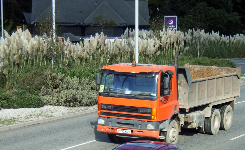 a red truck driving down a city street