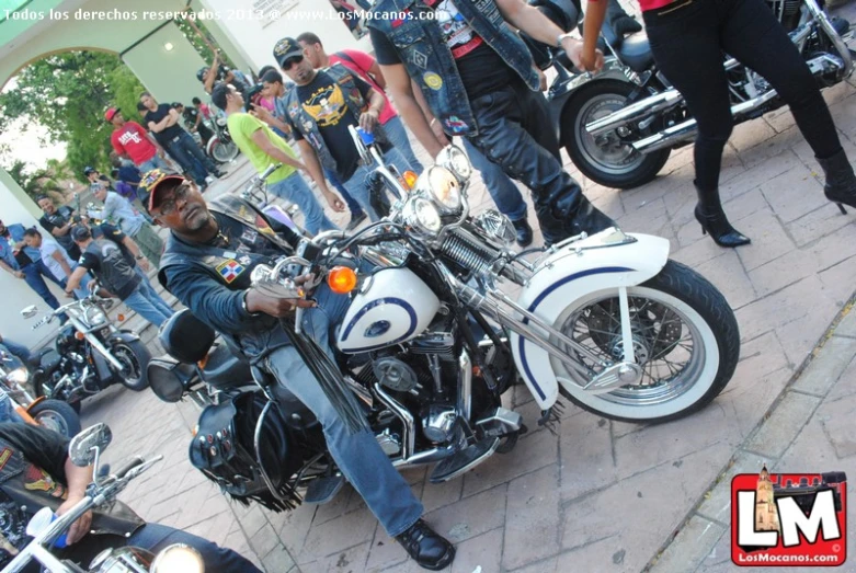 people are gathered around parked motorcycles at a rally