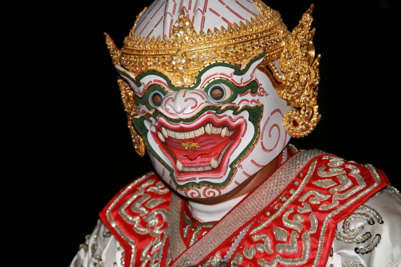 a man with gold face paint and head decoration