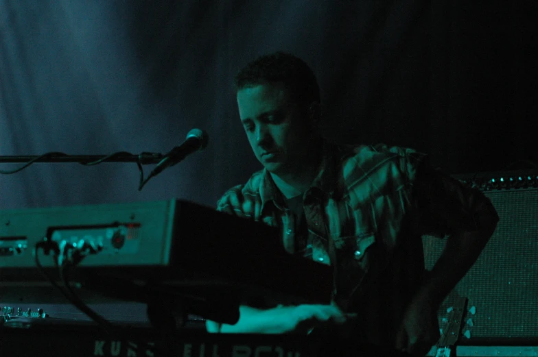 a person playing an electronic keyboard in a room