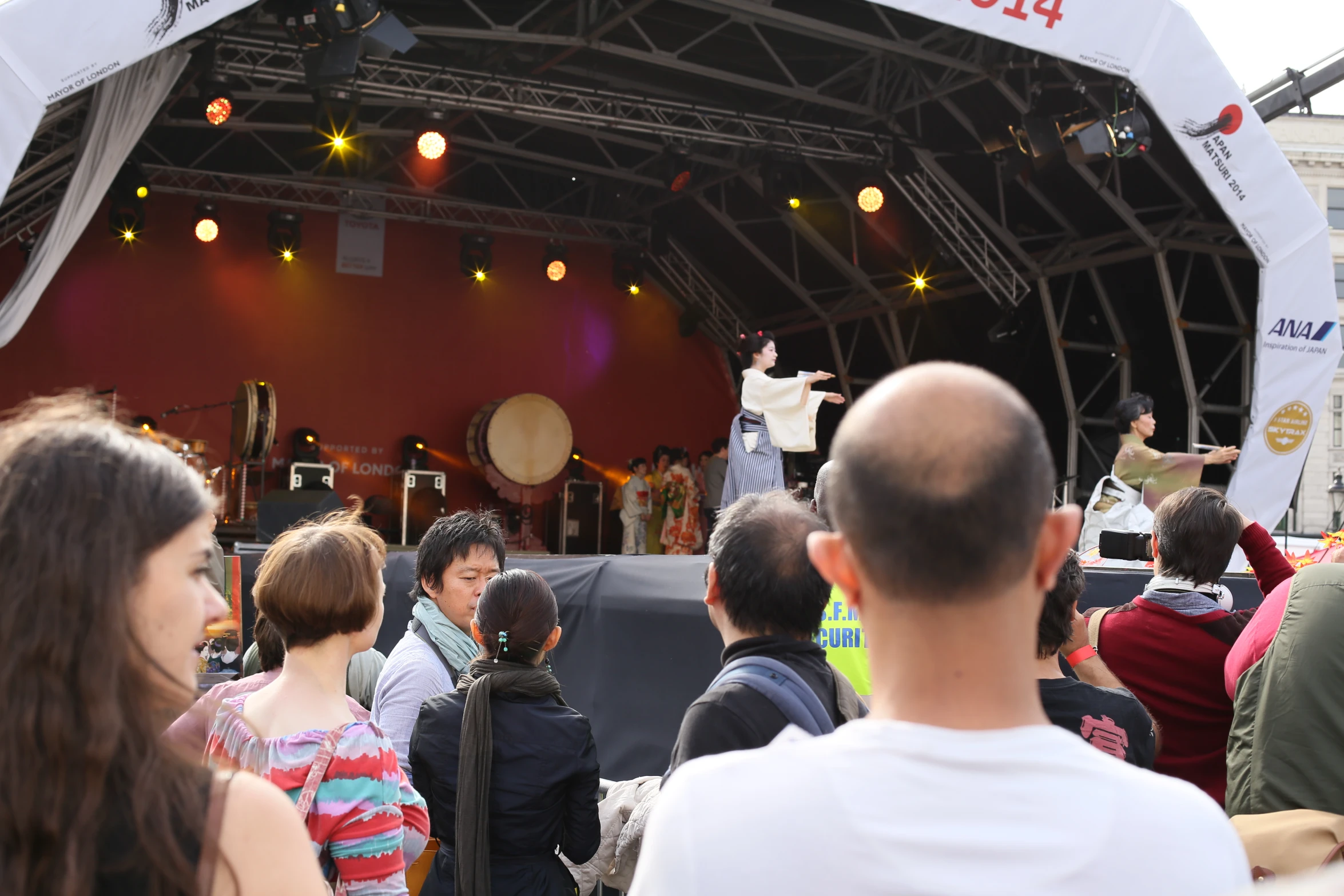 a group of people on stage and in the middle of the crowd