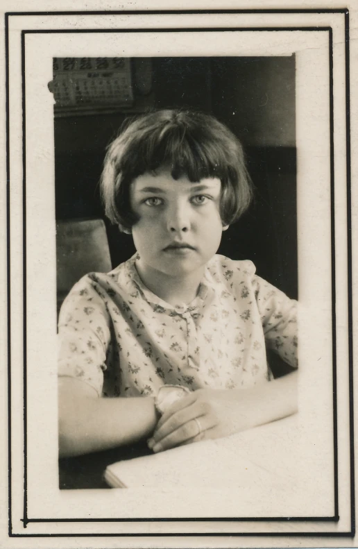 a vintage black and white po of a girl looking very bored