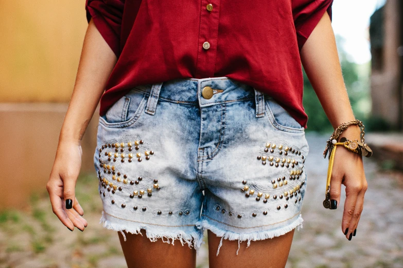 closeup of a woman in shorts with gold cuff celets