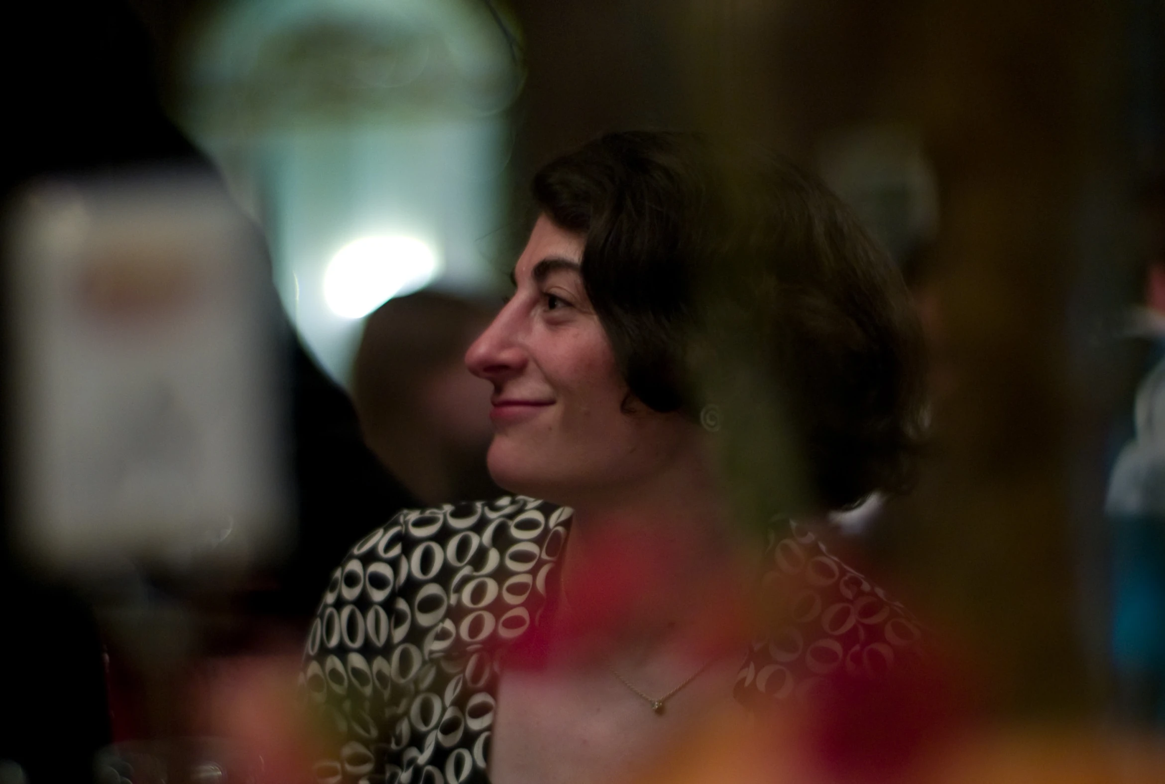 a woman is smiling at an event