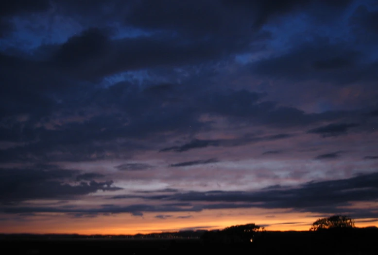 a view of the sunset over a field in england