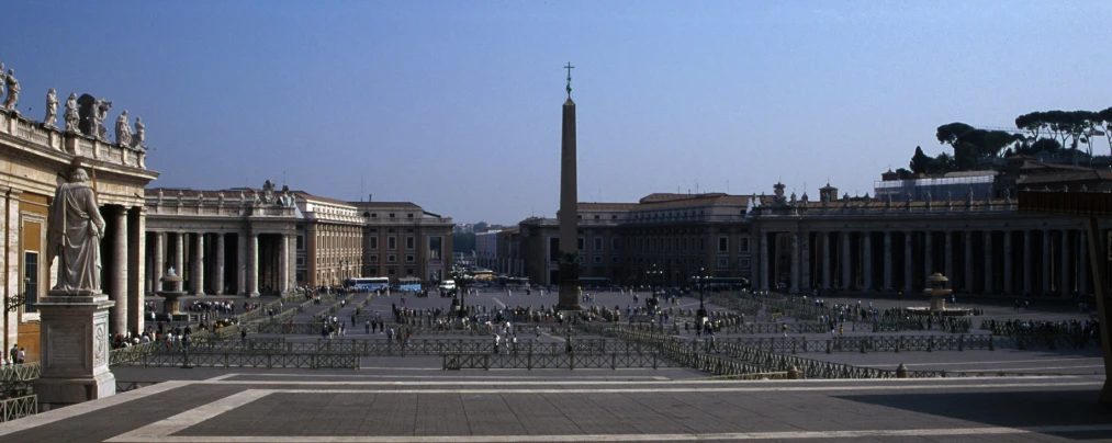 an old city square with tourists and statues