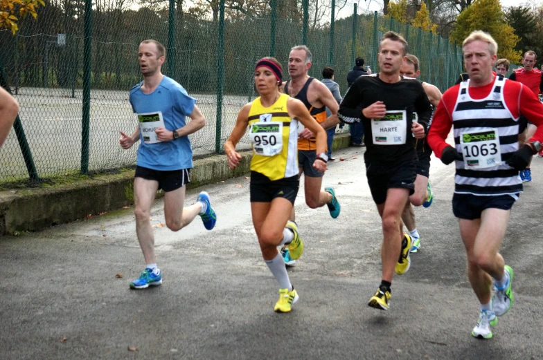 a group of runners run along a path