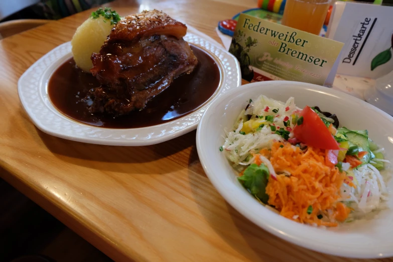 a close up of two plates of food with meat