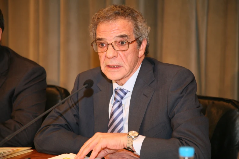 a close up of a person at a desk with a microphone