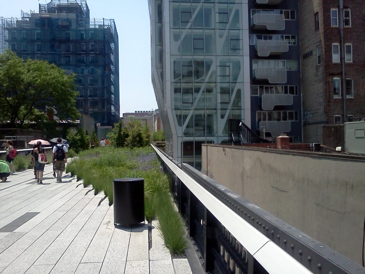 pedestrians walk along the empty urban side walk