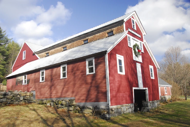 a barn with a red roof and white trim