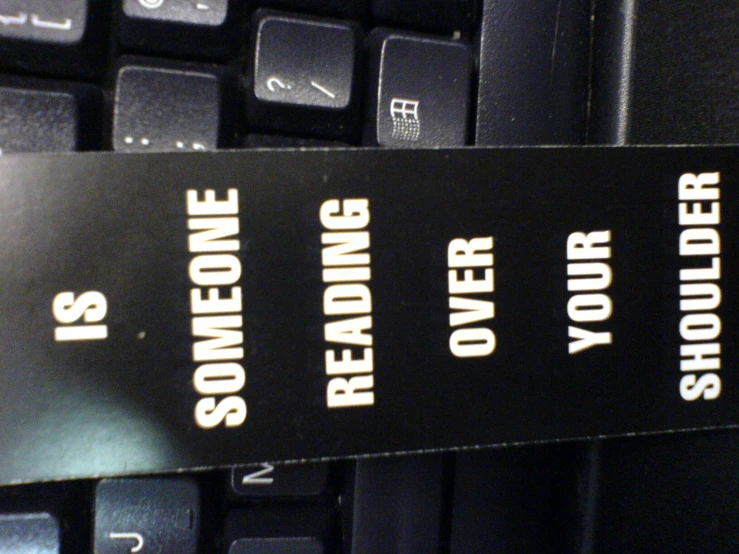 a label attached to a keyboard that says reads reading the records